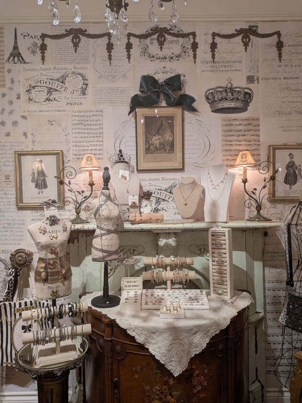 Vintage costume jewelry — brooches, bracelets and rings on Paris-themed busts