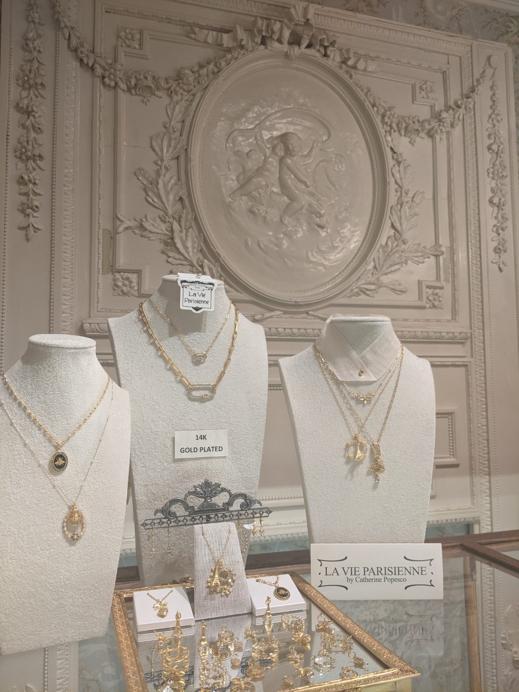 La Vie Parisienne gold-plated necklaces displayed on cream busts